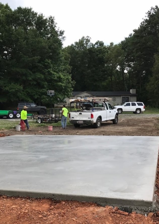 Concrete slab poured by workers