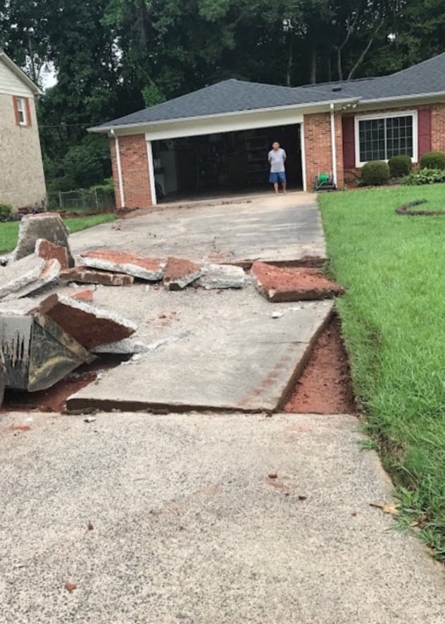 Old concrete driveway being broken apart and removed